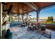 Inviting porch with comfortable seating, elegant ceiling, and tranquil water views at sunset at 108 Salthouse Ln, Kiawah Island, SC 29455
