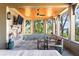 Cozy covered patio with a fireplace, TV, comfortable seating and scenic views at 108 Salthouse Ln, Kiawah Island, SC 29455
