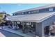 Exterior shot of The Village Market retail store with gray siding and plenty of parking at 108 Salthouse Ln, Kiawah Island, SC 29455
