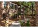 Charming brick home featuring a quaint wooden walkway surrounded by palms and lush greenery at 108 Salthouse Ln, Kiawah Island, SC 29455