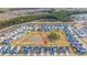 Wide aerial view of the neighborhood with a pond, trees, and orderly arranged houses at 1081 Magnolia Warbler Way, Ravenel, SC 29470