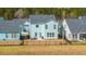 Backyard of a craftsman style home with patio furniture on the back porch at 1081 Magnolia Warbler Way, Ravenel, SC 29470
