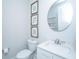 Stylish half-bathroom featuring a vanity with white countertops, a modern mirror, and soothing decor for a serene ambiance at 1081 Magnolia Warbler Way, Ravenel, SC 29470