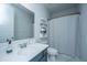 Bright bathroom with a sleek vanity, decorative mirror, and a stylish shower curtain, creating a serene retreat at 1081 Magnolia Warbler Way, Ravenel, SC 29470