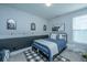 Cozy bedroom featuring blue accents, a full sized bed, and decorative artwork, creating a comfortable living space at 1081 Magnolia Warbler Way, Ravenel, SC 29470