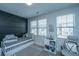 Bedroom featuring a daybed, a modern accent wall and a comfortable gaming chair to create a relaxing ambiance at 1081 Magnolia Warbler Way, Ravenel, SC 29470