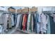 Organized walk-in closet with hanging clothes and shelving at 1081 Magnolia Warbler Way, Ravenel, SC 29470