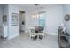A view of a modern dining area with table and white chairs and decor in a bright, airy space at 1081 Magnolia Warbler Way, Ravenel, SC 29470