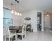 Bright dining area with a modern light fixture, round table, and stylish decor, perfect for gatherings at 1081 Magnolia Warbler Way, Ravenel, SC 29470