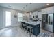 Contemporary kitchen with a large island, stainless steel appliances, and stylish pendant lighting at 1081 Magnolia Warbler Way, Ravenel, SC 29470