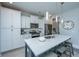 A modern kitchen features white cabinets, stainless steel appliances, and a stylish island with seating at 1081 Magnolia Warbler Way, Ravenel, SC 29470