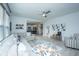Bright, open-concept living room featuring a plush sofa and view into the modern kitchen at 1081 Magnolia Warbler Way, Ravenel, SC 29470