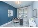 Well-lit home office with a sleek black desk, neutral chair and tasteful decor at 1081 Magnolia Warbler Way, Ravenel, SC 29470