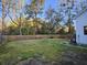 A large fenced backyard with a well-maintained lawn and mature trees at 110 Cypress St, Summerville, SC 29483