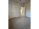 Carpeted bedroom with a closet and white trim with doors open into other rooms at 110 Cypress St, Summerville, SC 29483
