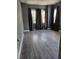 Bedroom with dark wood-look floors and natural light from several windows at 110 Cypress St, Summerville, SC 29483