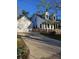 Charming two-story home with a white exterior, detached garage, a driveway and fenced front yard at 110 Cypress St, Summerville, SC 29483