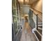 Bright foyer with wood-look floors, staircase with white risers and gray paneled walls at 110 Cypress St, Summerville, SC 29483
