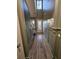 Hallway featuring a tall ceiling, wood-look floors, paneled walls, and natural light from the entry door at 110 Cypress St, Summerville, SC 29483