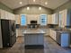 Bright kitchen with white cabinetry, stainless steel appliances, granite countertops and a central island at 110 Cypress St, Summerville, SC 29483