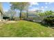 Large backyard with green grass, mature tree, and a wooden fence providing privacy at 112 Retriever Ln, Goose Creek, SC 29445