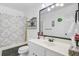 Well-lit bathroom with a shower/tub combo, tiled floor and a vanity with a large mirror at 112 Retriever Ln, Goose Creek, SC 29445