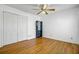 Bedroom with wood floors, ceiling fan, double-door closet, and dark bookshelf at 112 Retriever Ln, Goose Creek, SC 29445