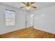 Bedroom with wood floors, ceiling fan, window and doorway to another room at 112 Retriever Ln, Goose Creek, SC 29445