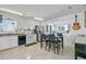 Bright dining area with white cabinets, laminate floors, and stainless steel appliances at 112 Retriever Ln, Goose Creek, SC 29445