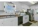 Updated kitchen featuring white cabinets, stainless steel refrigerator, black dishwasher, and a window with natural light at 112 Retriever Ln, Goose Creek, SC 29445
