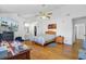 Spacious main bedroom showcasing hardwood floors, a ceiling fan, walk-in closet, and access to the bathroom at 112 Retriever Ln, Goose Creek, SC 29445