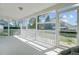 Screened porch with white railing offers outdoor living space with views of the yard and neighborhood at 112 Retriever Ln, Goose Creek, SC 29445