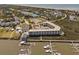 A scenic aerial view of waterfront condos, a marina, and a golf course near the ocean at 116 Bay Creek Villa, Edisto Beach, SC 29438