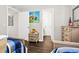 Comfortable bedroom with twin beds, colorful artwork, and neutral-colored walls at 116 Bay Creek Villa, Edisto Beach, SC 29438