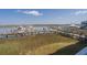 Scenic waterfront view with a dock, boats, and outdoor seating area on a clear day at 116 Bay Creek Villa, Edisto Beach, SC 29438