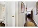 Hallway leading to a bathroom and an open living area with hardwood floors at 116 Bay Creek Villa, Edisto Beach, SC 29438