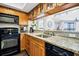 Well-appointed kitchen featuring modern appliances, wood cabinetry, and granite countertops at 116 Bay Creek Villa, Edisto Beach, SC 29438