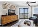 Comfortable living room boasting hardwood floors, a ceiling fan, and sliding glass doors to a waterfront balcony at 116 Bay Creek Villa, Edisto Beach, SC 29438