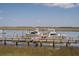 Picturesque view of boats docked at the marina under a clear blue sky on the water at 116 Bay Creek Villa, Edisto Beach, SC 29438
