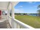 Inviting covered porch offering panoramic views of the community, the lake, and the green lawns at 122 Yorkshire Dr, Moncks Corner, SC 29461