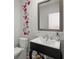 Charming half bathroom with modern fixtures, floral accents, and a decorative mirror creating a stylish space at 122 Yorkshire Dr, Moncks Corner, SC 29461