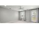 Bright bedroom with a ceiling fan, neutral walls, a door to a balcony, and plenty of natural light at 122 Yorkshire Dr, Moncks Corner, SC 29461