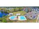 Aerial view of a community pool, splashpad, playground, and lakefront amenity center at 122 Yorkshire Dr, Moncks Corner, SC 29461