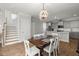 Open-concept space featuring a dining area with a modern chandelier that seamlessly connects to the kitchen at 122 Yorkshire Dr, Moncks Corner, SC 29461