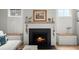 Close up of shiplap fireplace with black marble surround and hearth; rustic wooden mantle with decor at 122 Yorkshire Dr, Moncks Corner, SC 29461