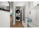 Convenient laundry area with modern washer and dryer units, storage, and a decorative bench at 122 Yorkshire Dr, Moncks Corner, SC 29461