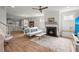Open concept living room with a fireplace, hardwood floors, and a view to the kitchen at 122 Yorkshire Dr, Moncks Corner, SC 29461