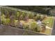 An aerial view of the sprawling property featuring a home, barns, manicured yard, and surrounding foliage inside a property line at 1298 French Santee Rd, Jamestown, SC 29453