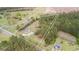 A high aerial shot of the property showcases the home, barns, and acreage that has neighboring houses nearby at 1298 French Santee Rd, Jamestown, SC 29453