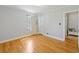 Bright bedroom with hardwood floors and neutral walls with a view into another room at 1298 French Santee Rd, Jamestown, SC 29453